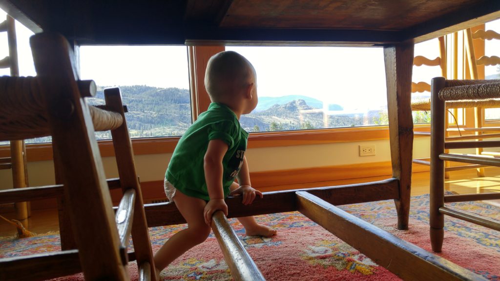 Ewan using the dinner table as a jungle gym