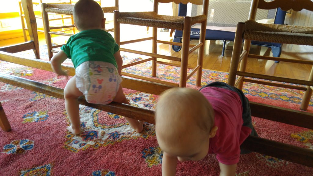 Ewan and Eileen using the dinner table as a jungle gym