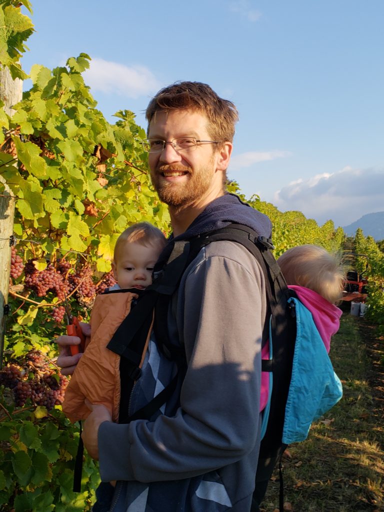 Kyle picking grapes with Eileen and Ewan