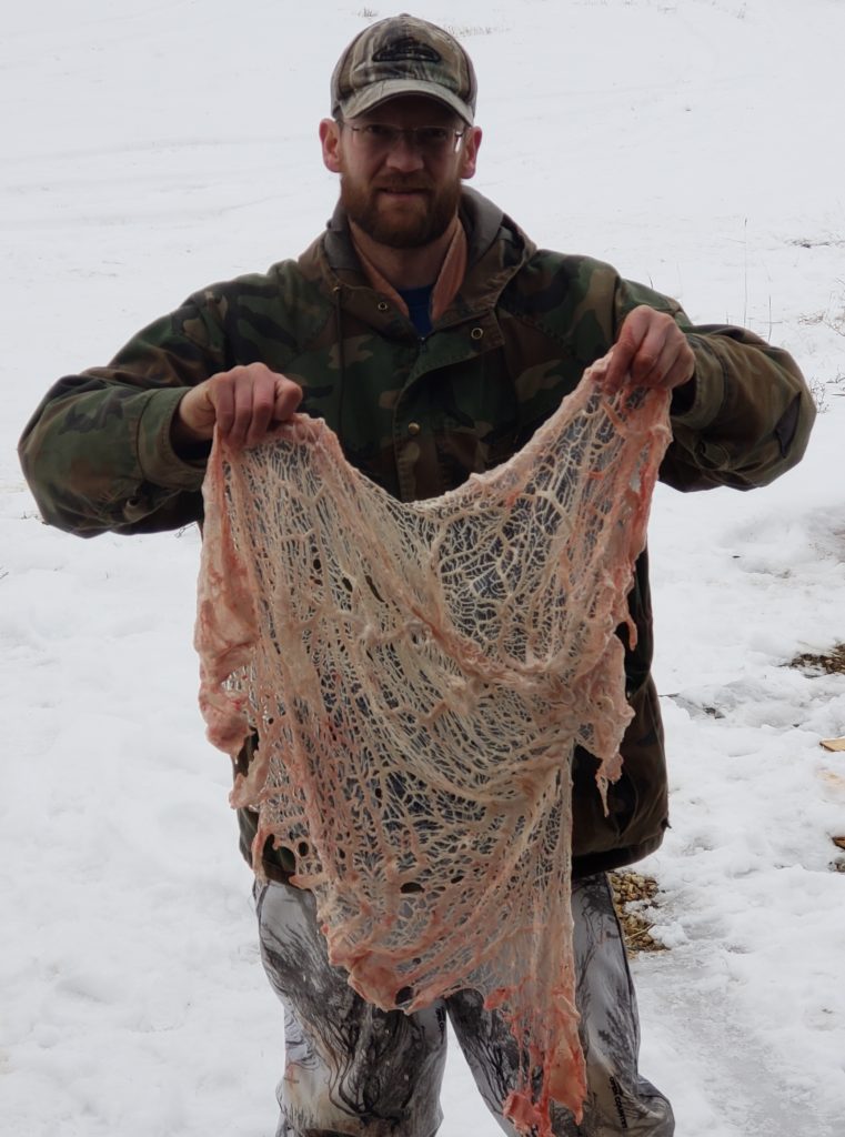 Kyle with caul fat from a deer